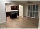 Open-concept living area showcasing the kitchen with stainless steel appliances, dark cabinets, and granite counters at 3480 E Sheffield Rd, Gilbert, AZ 85296