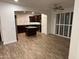 Open-concept living area showcasing the kitchen with stainless steel appliances, dark cabinets, and granite counters at 3480 E Sheffield Rd, Gilbert, AZ 85296