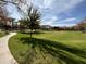 Lush green neighborhood park with winding sidewalks, mature trees, and open grassy area at 3480 E Sheffield Rd, Gilbert, AZ 85296