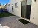 Private patio with artificial turf, brick pavers, slider to house, and views of neighboring house at 3480 E Sheffield Rd, Gilbert, AZ 85296