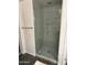 Modern shower with glass doors, gray tile, and built in shelving at 3480 E Sheffield Rd, Gilbert, AZ 85296
