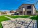 Beautiful backyard features a lush lawn, patio area, and two-story home with balcony at 3634 N Desert Oasis --, Mesa, AZ 85207