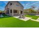 Inviting backyard features a lush lawn, patio area, and beautiful two-story home with balcony at 3634 N Desert Oasis --, Mesa, AZ 85207