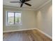 Bedroom with a modern ceiling fan, hardwood floors, and window showcasing a scenic view at 3634 N Desert Oasis --, Mesa, AZ 85207