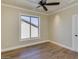 Bright bedroom featuring hardwood floors, ceiling fan, and a window offering ample natural light at 3634 N Desert Oasis --, Mesa, AZ 85207