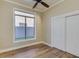 Light filled bedroom with hardwood floors, closet, and a window showcasing natural light at 3634 N Desert Oasis --, Mesa, AZ 85207