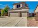 Beige two-story home featuring a three-car garage and well-maintained front yard, blending style and functionality at 3634 N Desert Oasis --, Mesa, AZ 85207