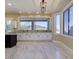 Bright kitchen with white cabinets, a black island, and marble floors, offering a stylish and functional space at 3634 N Desert Oasis --, Mesa, AZ 85207