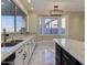 Bright kitchen with white cabinets, a black island, and marble floors, offering a stylish and functional space at 3634 N Desert Oasis --, Mesa, AZ 85207