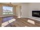 Living room with hardwood floors, a fireplace, and large windows offering scenic views, blending comfort and style at 3634 N Desert Oasis --, Mesa, AZ 85207