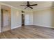 Spacious living room featuring hardwood floors, neutral paint, and modern ceiling fan at 3634 N Desert Oasis --, Mesa, AZ 85207