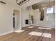 Open living room with a fireplace, wood floors, and a modern light fixture at 3634 N Desert Oasis --, Mesa, AZ 85207