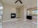Open-concept living space with a modern fireplace, built-in shelves, and marble floors, flowing into the kitchen at 3634 N Desert Oasis --, Mesa, AZ 85207