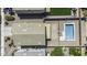 An aerial view showcases a backyard pool, grass lawn, and exterior features of this property at 36562 W Nina St, Maricopa, AZ 85138