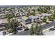 Wide aerial shot of the home in a neighborhood with many other single-Gathering homes at 36562 W Nina St, Maricopa, AZ 85138