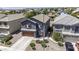 Aerial view of a two-story home featuring a gray stucco exterior and a two-car garage at 36562 W Nina St, Maricopa, AZ 85138