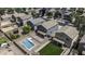 Aerial view of a home with a backyard pool, patio, and green lawn, surrounded by neighboring houses at 36562 W Nina St, Maricopa, AZ 85138