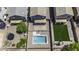 Aerial view of backyard featuring a swimming pool, green lawn, patio and surrounding fenced yard at 36562 W Nina St, Maricopa, AZ 85138