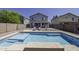 Backyard pool with baja step and lounge chairs offering great place for relaxing and entertaining outdoors at 36562 W Nina St, Maricopa, AZ 85138