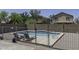 Backyard pool features sun deck with lounge chairs and fenced in yard area for outdoor privacy at 36562 W Nina St, Maricopa, AZ 85138