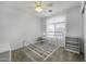 Bright bedroom featuring an open white metal bedframe and ample natural light from a large window at 36562 W Nina St, Maricopa, AZ 85138