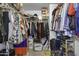Walk-in closet with rods, shelves, clothes, shoes, bags and plenty of storage at 36562 W Nina St, Maricopa, AZ 85138