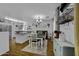 Bright dining area with an eat-in kitchen, wood floors and modern decorations at 36562 W Nina St, Maricopa, AZ 85138