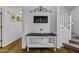 Entryway with stairs, console table, hardwood floors and decor with a warm welcome sign at 36562 W Nina St, Maricopa, AZ 85138