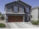 Two-story home featuring a gray stucco exterior and a two-car garage at 36562 W Nina St, Maricopa, AZ 85138