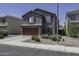 Charming two-story home featuring a gray stucco exterior and a two-car garage at 36562 W Nina St, Maricopa, AZ 85138