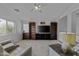 Bright and airy living room with a ceiling fan, plush seating, and a large television at 36562 W Nina St, Maricopa, AZ 85138