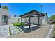 Backyard with a covered patio, artificial turf, rock landscaping, and pavers at 3831 N 8Th St, Phoenix, AZ 85014