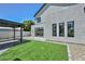 A lush backyard showcases artificial turf, rock features, a covered patio, and sleek exterior finishes at 3831 N 8Th St, Phoenix, AZ 85014