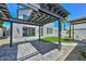 Backyard featuring artificial turf, pavers, rock landscaping, a covered patio, and contemporary exterior at 3831 N 8Th St, Phoenix, AZ 85014