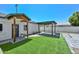 Backyard features artificial turf, pavers, rock landscaping, a covered patio, and a wood beam entry at 3831 N 8Th St, Phoenix, AZ 85014