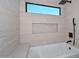 Bright bathroom view with a bathtub, rainfall shower head, and recessed niche for storage or decor at 3831 N 8Th St, Phoenix, AZ 85014