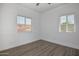 Bright bedroom featuring hardwood floors, a ceiling fan, and windows with blinds providing natural light at 3831 N 8Th St, Phoenix, AZ 85014