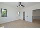 Inviting bedroom with laminate floors, a modern ceiling fan, windows, and an attached closet at 3831 N 8Th St, Phoenix, AZ 85014