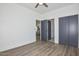 Spacious bedroom featuring wood-look flooring, closet, and a view into the kitchen, blending style and functionality at 3831 N 8Th St, Phoenix, AZ 85014