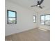 Bright bedroom with laminate floors, three windows, and a modern ceiling fan at 3831 N 8Th St, Phoenix, AZ 85014