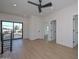 Bright bedroom with wood-look floors, a ceiling fan, recessed lighting, and a balcony with black railings at 3831 N 8Th St, Phoenix, AZ 85014