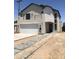 Modern two-story home featuring a white brick accent wall and a concrete driveway with decorative gray pavers at 3831 N 8Th St, Phoenix, AZ 85014