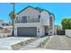 Beautiful two-story home with a gray two car garage and manicured front yard at 3831 N 8Th St, Phoenix, AZ 85014