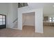 Bright foyer featuring light wood-look flooring, stairs leading to a second story, and an open entry to the kitchen at 3831 N 8Th St, Phoenix, AZ 85014