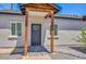 Inviting front entrance featuring a gray door, wooden support beams, and a paved walkway, enhancing curb appeal at 3831 N 8Th St, Phoenix, AZ 85014