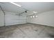 Spacious garage with white walls, concrete floors, large door, and bright lighting fixtures at 3831 N 8Th St, Phoenix, AZ 85014