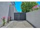 Private gate with flower bushes providing access to backyard at 3831 N 8Th St, Phoenix, AZ 85014