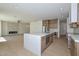 A modern kitchen offers an island with waterfall countertops next to a living space and a fireplace at 3831 N 8Th St, Phoenix, AZ 85014