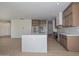 Open kitchen featuring an island with white countertops, wooden cabinets, and stainless steel appliances at 3831 N 8Th St, Phoenix, AZ 85014