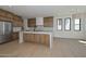 Spacious kitchen with stainless steel appliances, wooden cabinets and a large island with white countertops at 3831 N 8Th St, Phoenix, AZ 85014